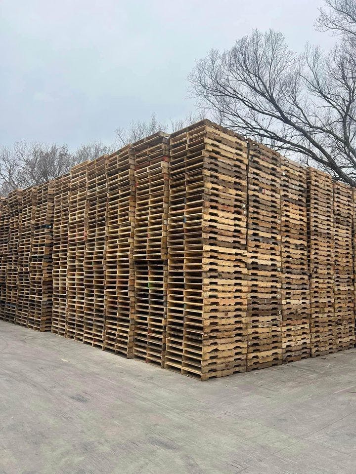 Stacks of Used Grade B Pallets in TX